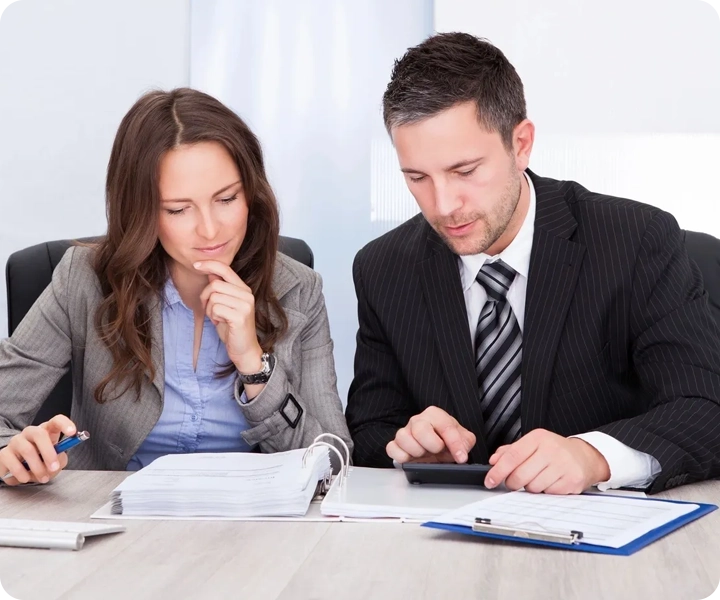 A man and woman are working on paperwork.